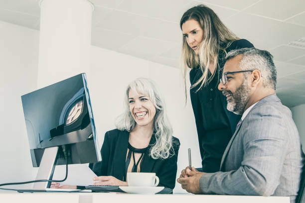 istock Happy business group watching presentation and laughing 1298893867