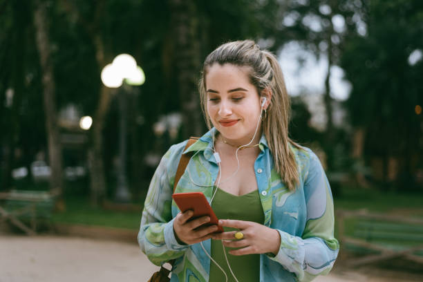 istock Walking in the city using smartphone 1298894320