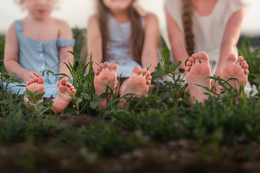 feet of a child on green grass