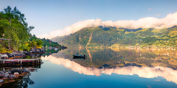 Picturesque summer panorama on the Norwegian fjord, located near Lofthus village in Ullensvang municipality, Hordaland county, Norway. Beauty of countryside concept background.