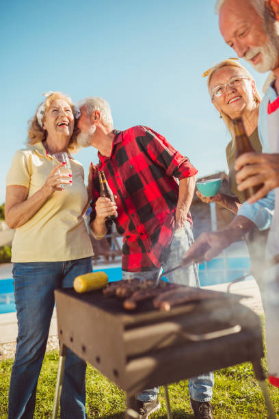 istock Senior people having backyard barbecue party 1298895813