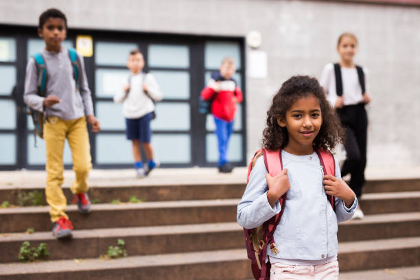 istock Curly a tween girl walking to school campus after lessons 1298900974