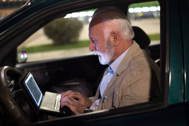 istock Senior man using digital tablet in the car 1298901262