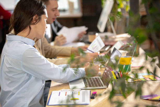 istock Young caucasian colleagues working together in a office using modern devices and gadgets 1298901698