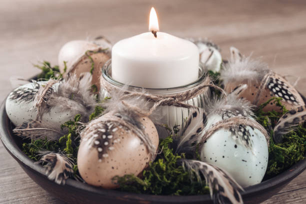 istock Spring decor ideas Diy. How to make Easter floral arrangement with decorative eggs, candle and moss. 1298903145