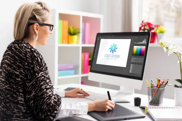 Graphic design artist working at the office on client's logo design
