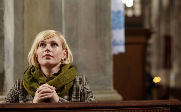 Young woman praying in a church.