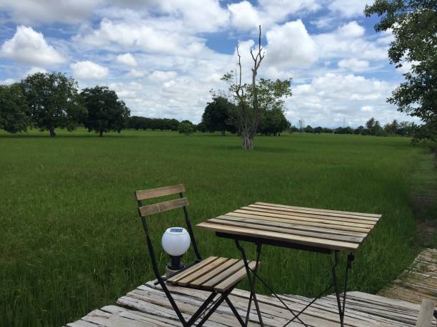 istock A table set on a wooden bridge with a field 1298904282