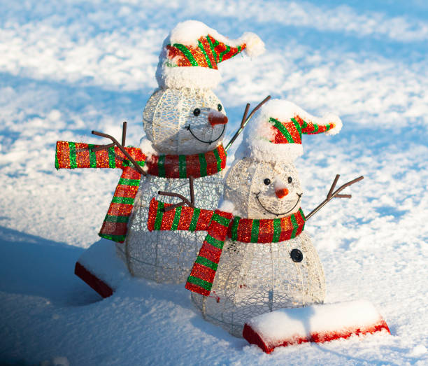 istock Two snowmen on a sled decoration on the snow 1298908198