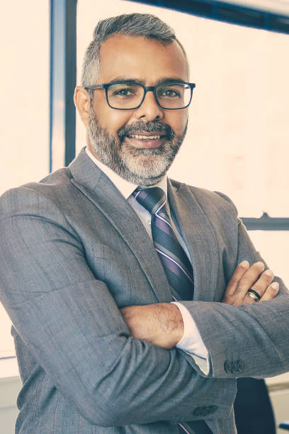 istock Experienced businessman standing in office room 1298908790