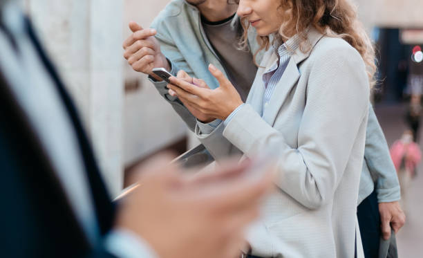 istock passengers using their smartphones while standing in the subway crossing 1298908975