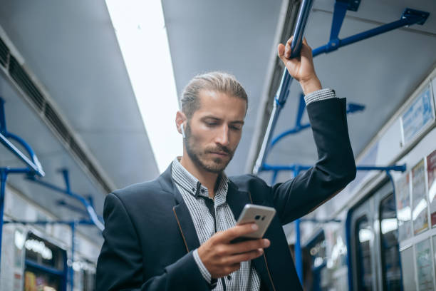 business man checking his email correspondence in the subway