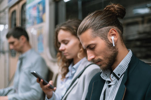 istock passengers using smartphones in the subway car 1298909191