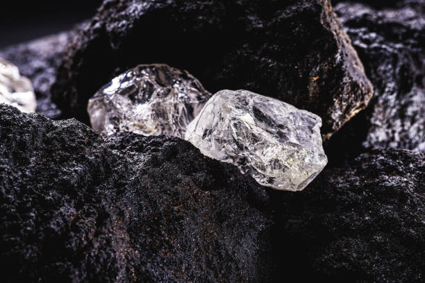 Rough diamond, precious stone in mines. Concept of mining and extraction of rare ores. Rough diamond, precious stone in mines. Concept of mining and extraction of rare ores. diamond gemstone stock pictures, royalty-free photos & images