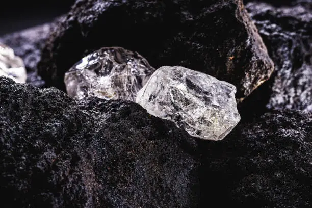 Photo of Rough diamond, precious stone in mines. Concept of mining and extraction of rare ores.