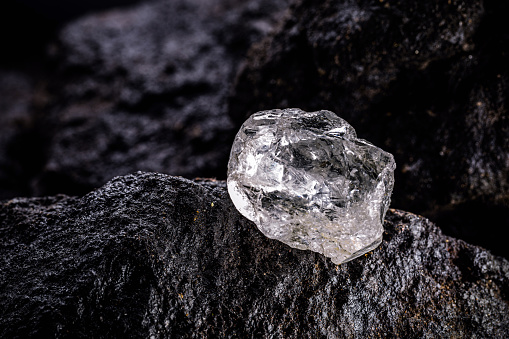large uncut diamond stone in a natural state within a mine. Concept of beauty, luxury and rare jewel
