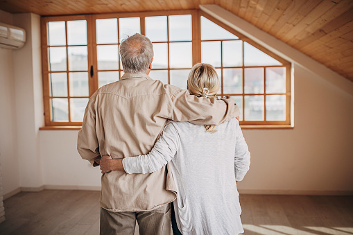 Happy senior couple in their empty new apartment