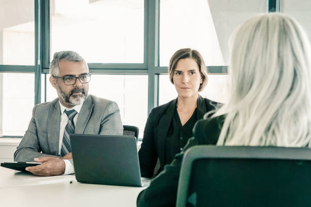 istock Two employers talking to professional at job interview 1298910785