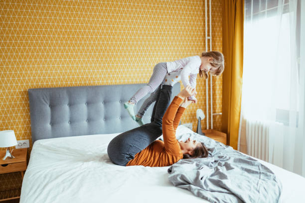 istock Mother and daughter playing in bedroom 1298911448
