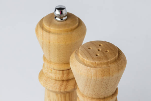 istock Wooden mills with salt and pepper on white 1298911514