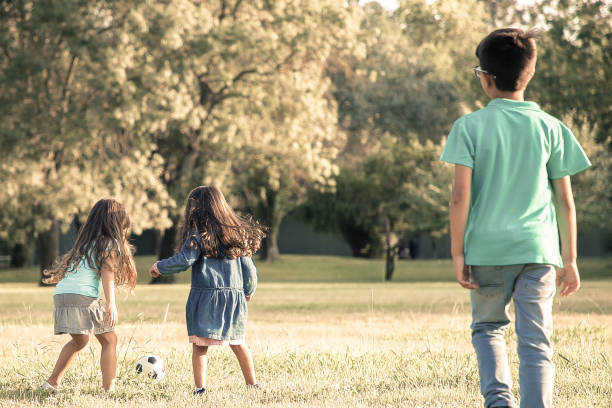 istock Active children playing football on grass 1298917502
