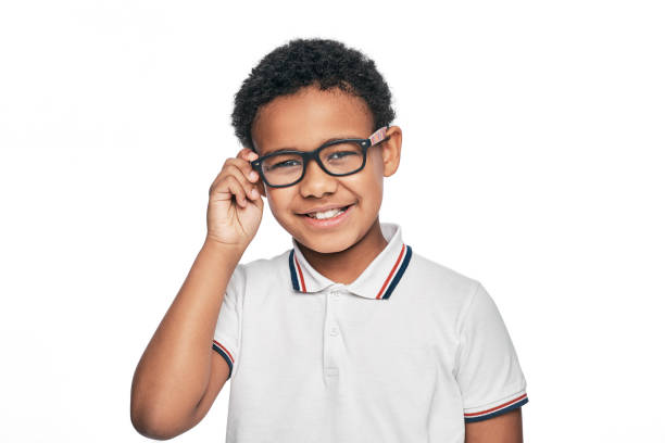 Smiling African American child with stylish eyeglasses, isolated on white background. Vision correction for children Smiling African American child with stylish eyeglasses, isolated on white background. Vision correction for children myopia photos stock pictures, royalty-free photos & images