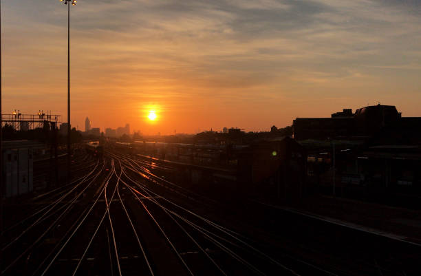 The sun rises over the city of London skyline