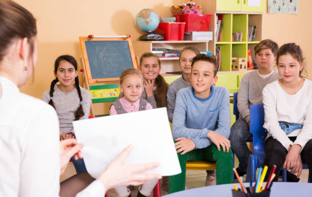 istock Elementary age group of pupil  listening teacher and sitting 1298929249
