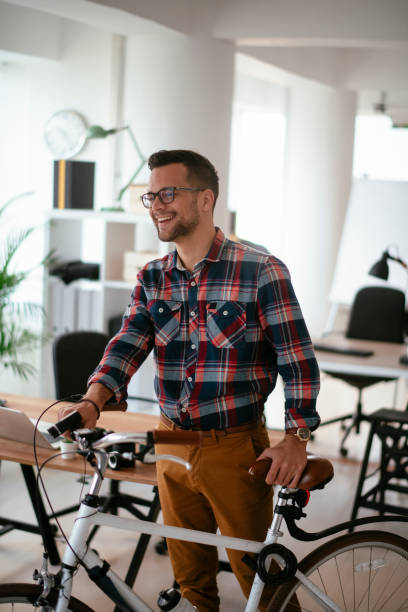 istock Young businessman with a bicycle in the office. 1298931441