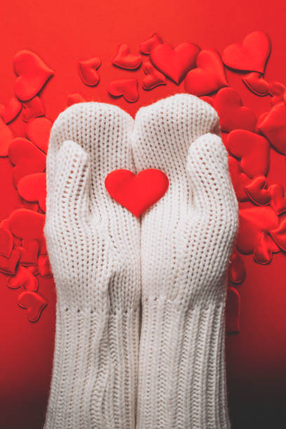 istock Hands in white gloves hold red hearts 1298931939