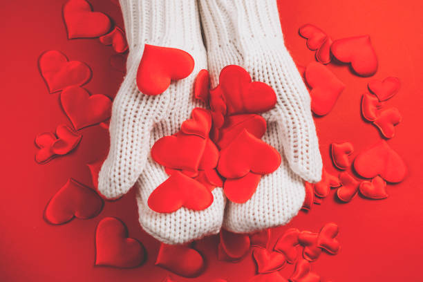 istock Hands in white gloves hold red hearts 1298931944