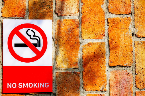 No smoking sign on wall background