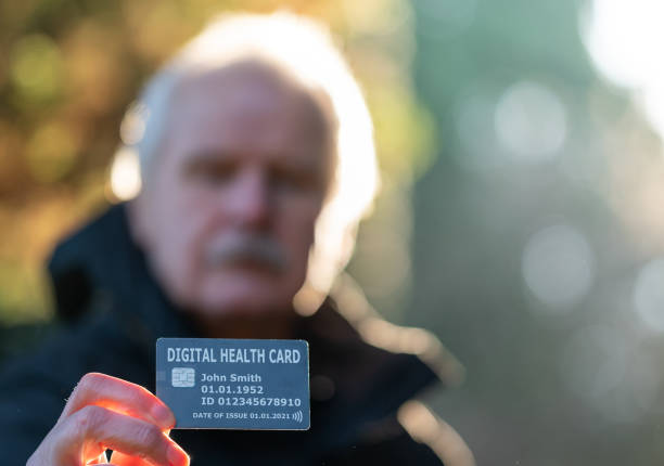 istock Senior citizen showing a digital health card. 1298934224