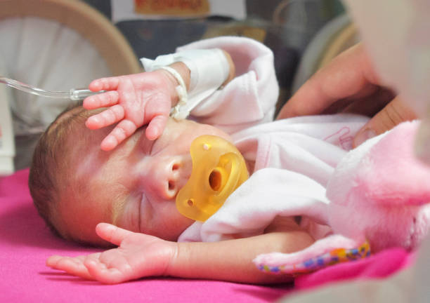 istock Preterm baby sleeping in NICU 1298934631