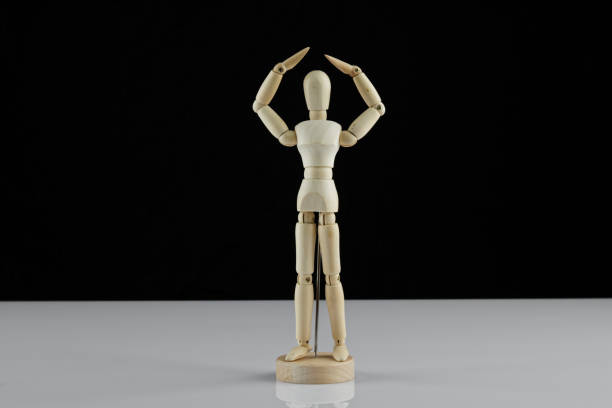 istock wooden human model poses on the table 1298936401