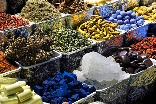 Herbs, spices, dried fruits, menthol crystals, blue dye at the old market in Dubai, United Arab Emirates.