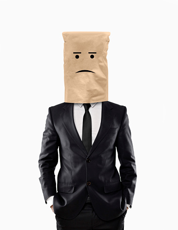 Sad businessman with paper bag over his head