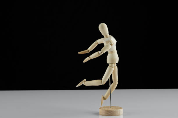 istock wooden human model poses on the table 1298940683