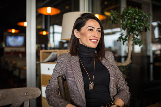 istock Happy beautiful woman in cafe 1298942020