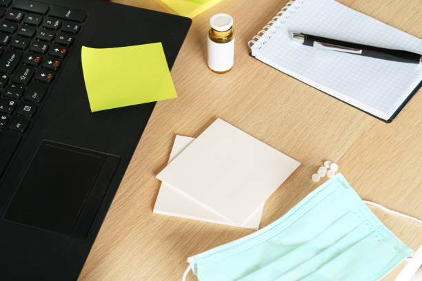 istock Medical protective mask on office table. Coronavirus spread prevention concept 1298942168
