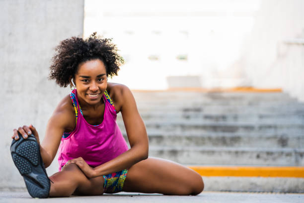 istock Afro athlete woman stretching legs before exercise. 1298944009