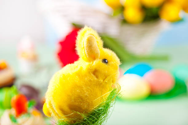 istock Easter funny yellow bunny and Easter celebrate table on background 1298944099