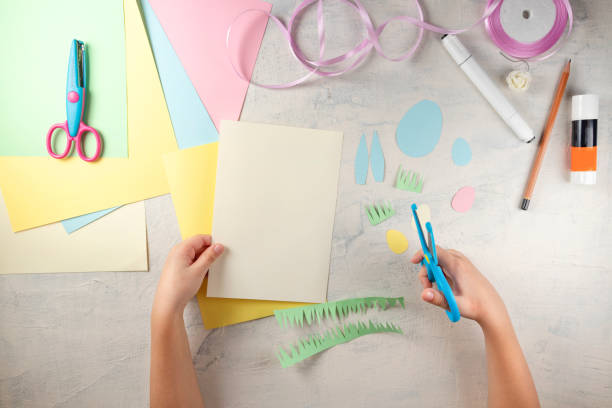 istock DIY and kids creativity. Step by step instruction: how to make card Happy easter. Step1 preparation tools colored paper, scissors, glue, pencil, ribbon, marker 1298947064