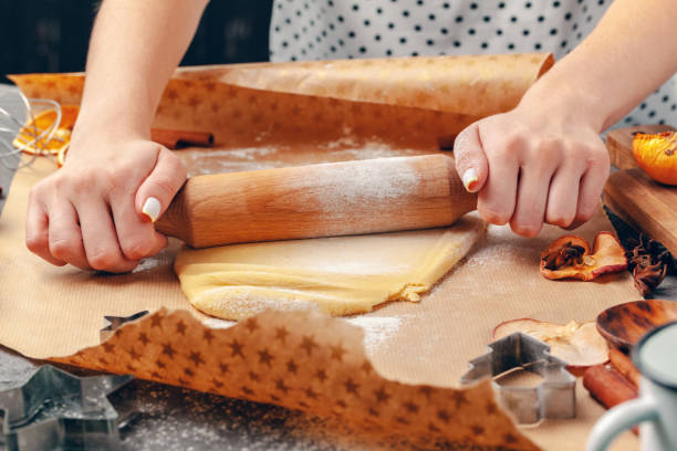 istock Close up of Woman's hands preparing dough for cookies 1298947200