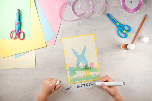 istock DIY and kids creativity. Step by step instruction: how to make card Happy easter. Step6 cut out notes and write the words Happy Easter. Childrens handmade Easter craft 1298947426