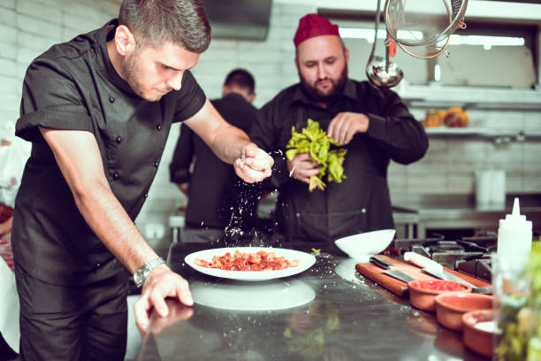 istock Cook Seasoning Macaroni Dish In Restaurant Kitchen 1298949153