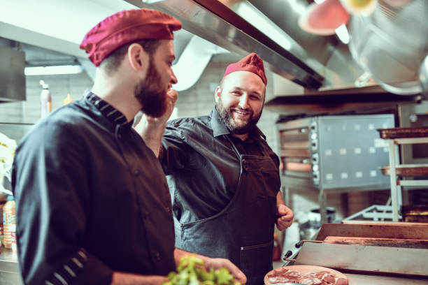 istock Friendship Between Chef Coworkers In Kitchen 1298949355