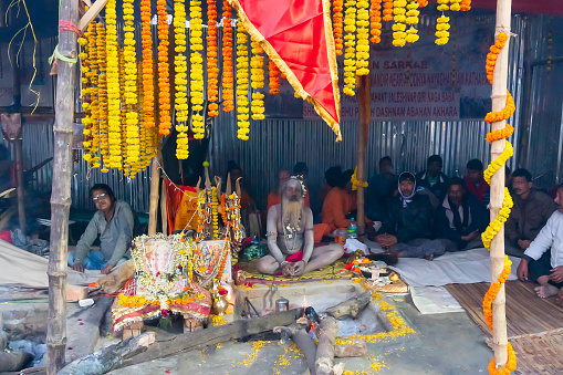 Kolkata, West Bengal, India - 12th January 2020 : Hindu Sadhu dressed in garland, safron and white ash at Gangasagar transit camp, Kolkata.