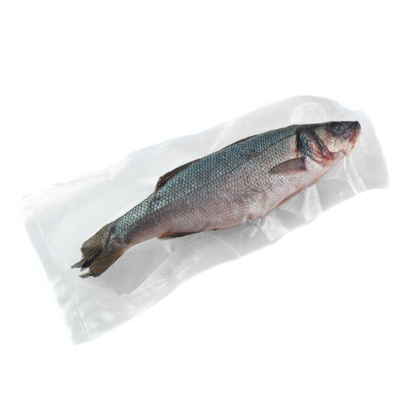 istock Frozen sea bass. In plastic vacuum packaging. White background. Isolated. View from above. 1298951555