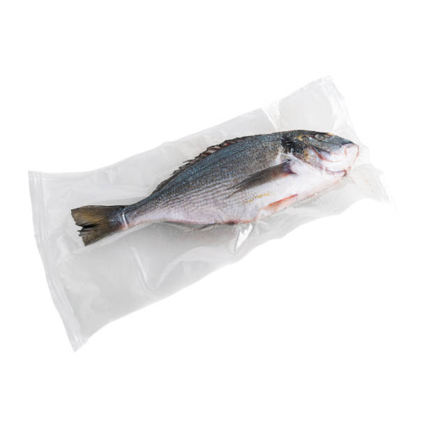 istock Frozen dorado fish. In plastic vacuum packaging. White background. Isolated. 1298951891